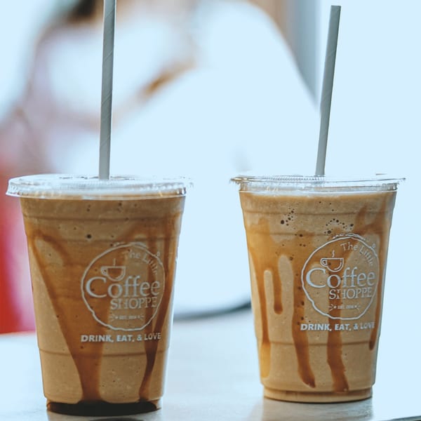 Two Little Coffee Shoppe iced coffee drinks with caramel drizzle and straws.